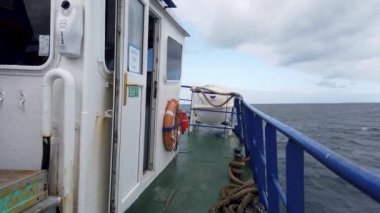 MAGHERAROARTY, COUNTY DONEGAL, IRELAND - AUGUST 25 2022 : The ferry is driving through rough sea between Magheraroarty and Tory Island.