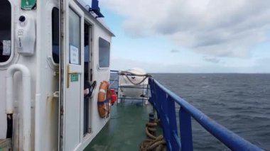MAGHERAROARTY, COUNTY DONEGAL, IRELAND - AUGUST 25 2022 : The ferry is driving through rough sea between Magheraroarty and Tory Island.