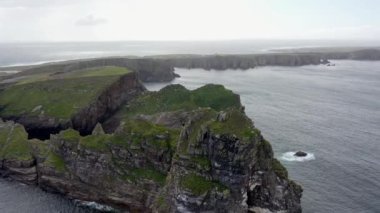 The cliffs and sea stacks An Tor Mor and the Wishing Stone at Port Challa on Tory Island, County Donegal, Ireland.