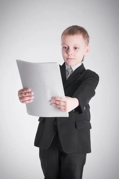 Boy looks on paper — Stock Photo, Image
