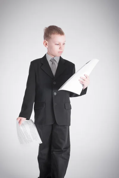 Boy holds two packages of papers — Stock Photo, Image