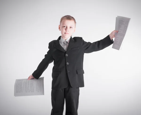 Boy waving bundles of paper — Stock Photo, Image