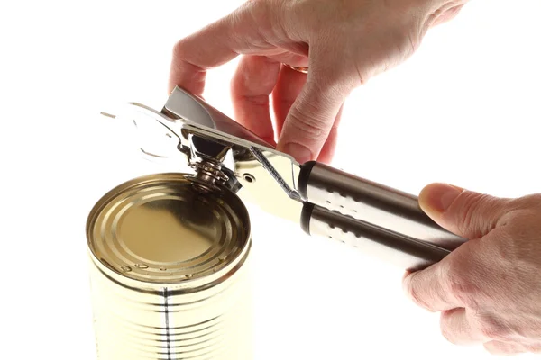 Hand and Tin opener opening a can of food isolated on white — Stock Photo, Image