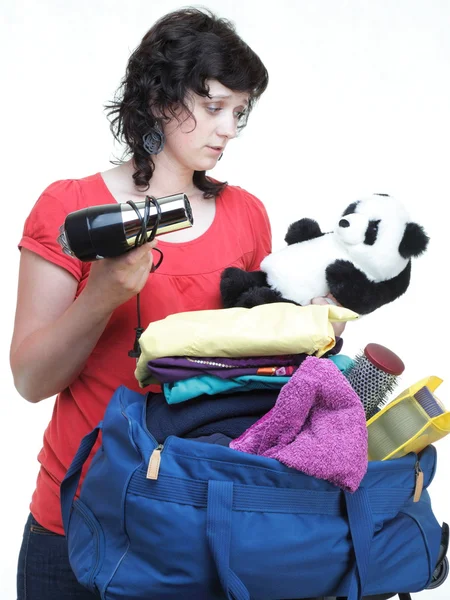 Woman hand crammed full of clothes and shoulder bag isolated — Stock Photo, Image