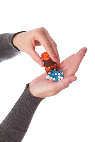 Blue - white pills in woman hand — Stock Photo, Image