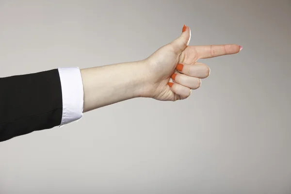 Mujer mano apuntando dirección con el dedo índice — Foto de Stock