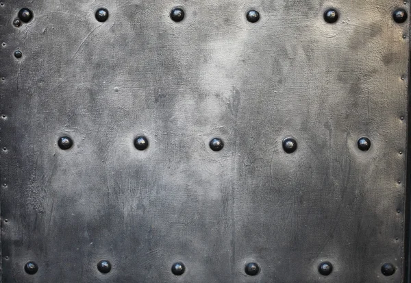 Black metal plate or armour texture with rivets — Stock Photo, Image