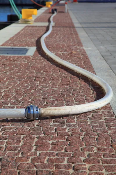 Bollard, port detail Fire hose — Stock Photo, Image