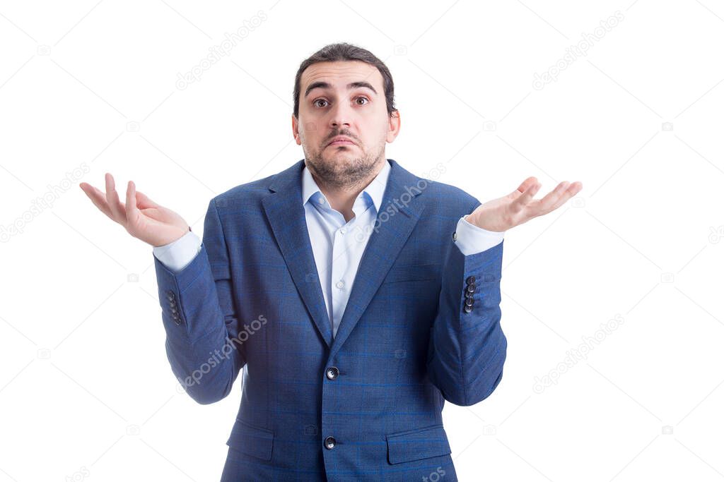 Clueless and perplexed businessman shrugging shoulders, hands outstretched, has doubts. Puzzled business person spreads his arms expressing uncertainty isolated on white background