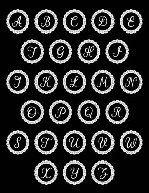 Alphabet, A to Z script monogram initials on eyelet lace doilies, isolated on black background. 