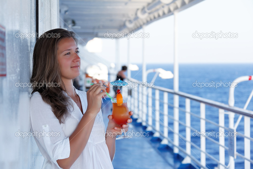 Cute girl with a cocktail on a journey
