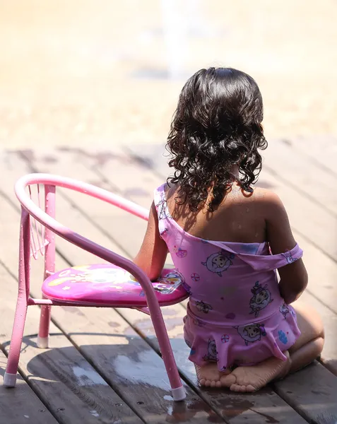 Girl with a chair, sitting in the shade — Stock Photo, Image