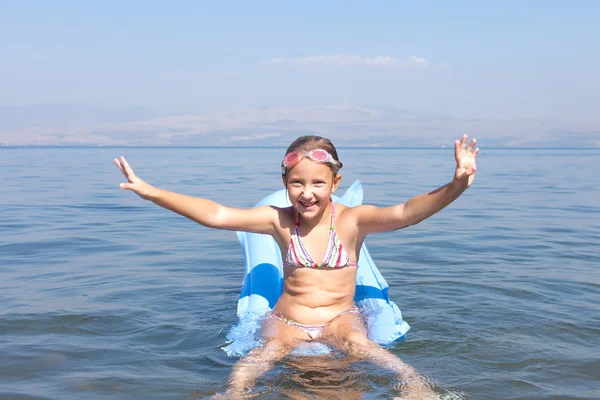 Girl swim on a mattress — Stock Photo, Image