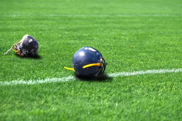 Helmet rugby lying in the field — Stock Photo, Image