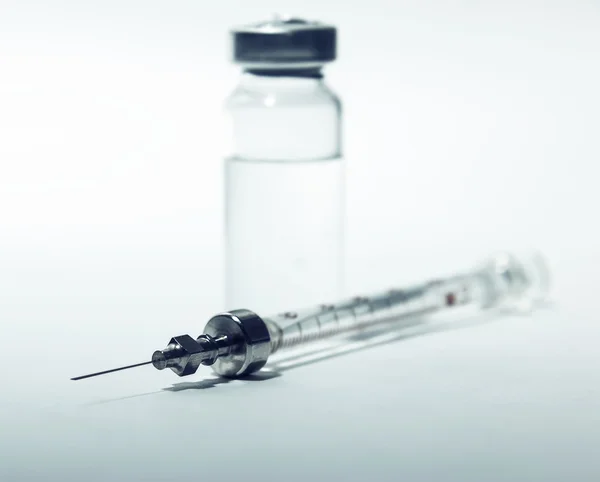 Syringe with bottle closeup — Stock Photo, Image