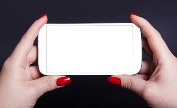 White mobile phone in a female hand — Stock Photo, Image