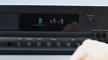 Teyp yakın plan, kadın stop düğmesine basıyor ve CD 'yi açıyor.