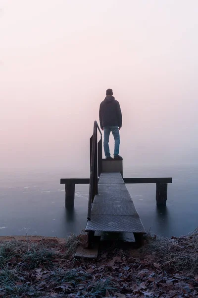 Young Caucasian Man Jacket Standing Pond Water Gate Misty Fog — Stock Photo, Image