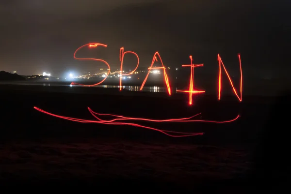Spain Written With Red Torch Light. — Stock Photo, Image