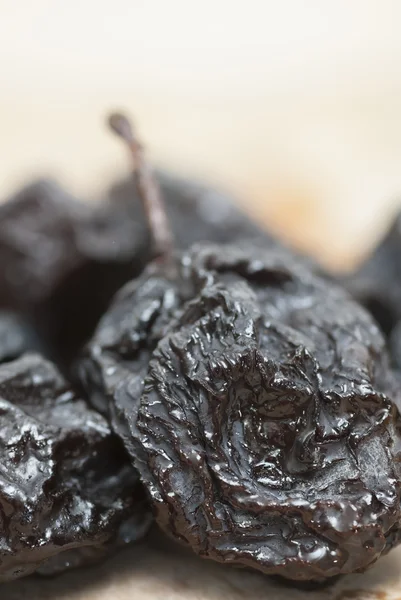 Prunes on Wooden Chopping Board. — Stock Photo, Image