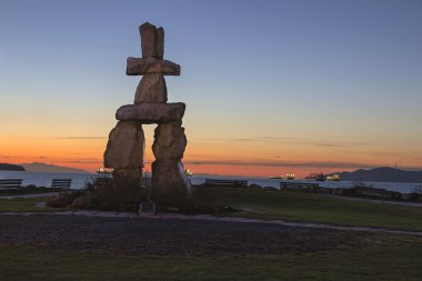 Inukshuk Stone Sculpture Sunset Beach Vancouver BC at Sunset clipart