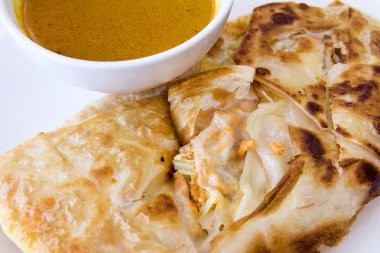 Indian Roti Prata with Curry Sauce Closeup clipart