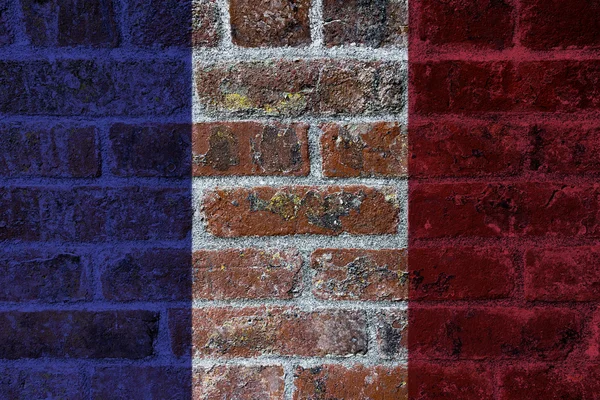 Drapeau français sur fond de mur de briques — Photo