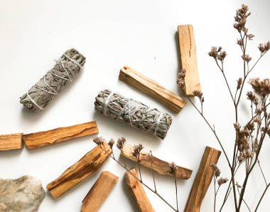 Palo santo ve beyaz adaçayı, aromaterapi ve beyaz arka planda tütsü. Metin yeri, dinsel minimalist arkaplan