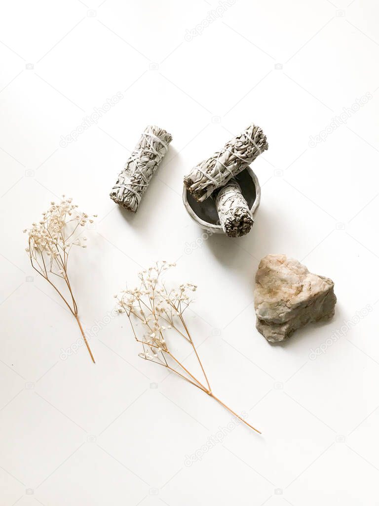 bunches of white California sage on a white background, minimalism and a place for text. sacred incense, aromatherapy and meditation