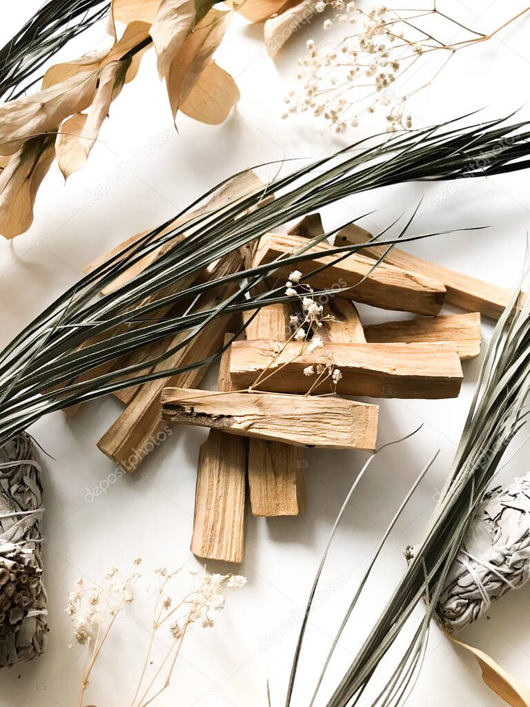 beautiful layout of palo santo and white sage, aromatherapy and incense on a white background. Place for text, religious minimalistic background