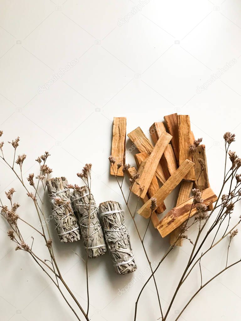 beautiful layout of palo santo and white sage, aromatherapy and incense on a white background. Place for text, religious minimalistic background