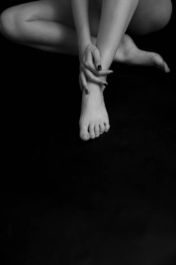 Naked woman body on black background. Fine art photo of female body.