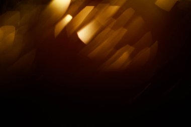 Turuncu Bokeh 'in soyut geçmişi, yeni yıl konsepti. Bulanık odak içinde küçük ışıklar