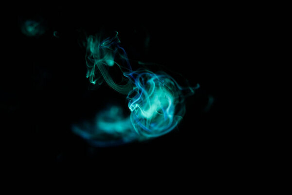 Green smoke pattern, beautiful puffs of smoke from cigarettes and hookah in the dark