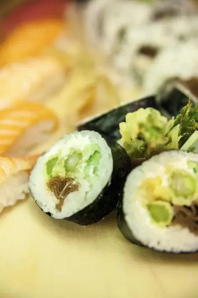 Futomaki Asparagus and blurred Nigiri and California Roll — Stock Photo, Image
