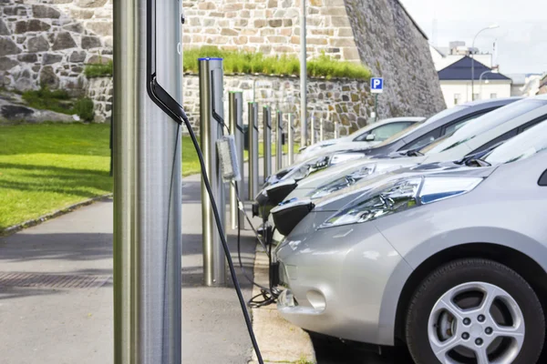 Elbilen ansluten till Elηλεκτρικό αυτοκίνητο στην πρίζα στην ηλεκτρική ενέργεια — Stockfoto