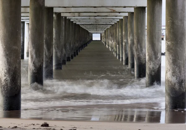 Onder een lange pier — Stockfoto