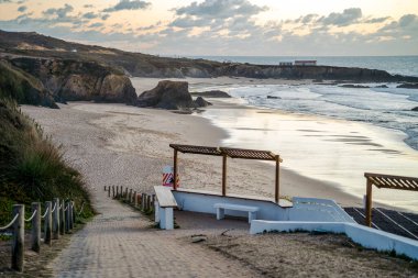 Nice Almograve sandy beach with cliffs at sunset, Alentejo, Portugal 