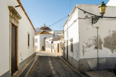 Faro, Algarve, Portekiz 'de beyaz boyalı binaları olan dar bir sokak.