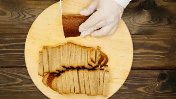 Cook Cuts Brown Bread Slices Cutting Board Man Cuts Dark — Vídeos de Stock