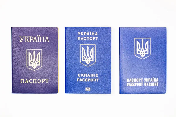 Passport of Ukraine. Three cover of the State document of the foreign Ukrainian Passport with the coat of arms of Ukraine in blue on a white background with an electronic chip. Isolated. Top view