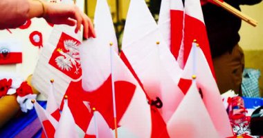 National Independence Day of Poland. Flag of Poland. The seller puts up for sale Polish flags with the coat of arms, wreaths, key chains and other souvenirs. Celebration in the Warsaw