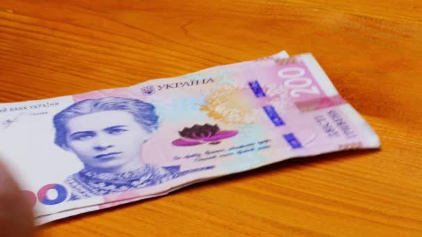 Recalculation Money Hands Count Banknotes Ukrainian Hryvnia Background Orange Wooden — стоковое видео
