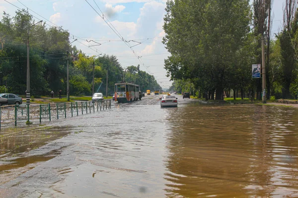 Flood. Road and cars under water. Heavy rain and downpour flooded city streets with water. strong deluge. Natural anomaly. Bad weather. Cataclysm. Cars and public transport are in a puddle. Nature