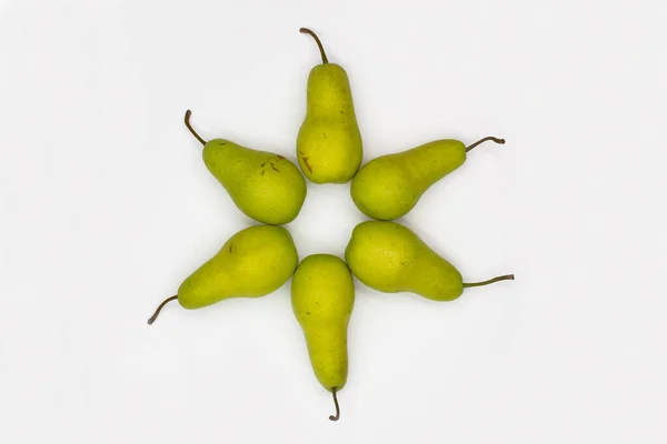 Star of David made from pears on white background. Ripe pears laid out in the shape of an eight-pointed Star of David - a symbol of Jewish identity Judaism.  Sweet and juicy pears. Close-up. Top view