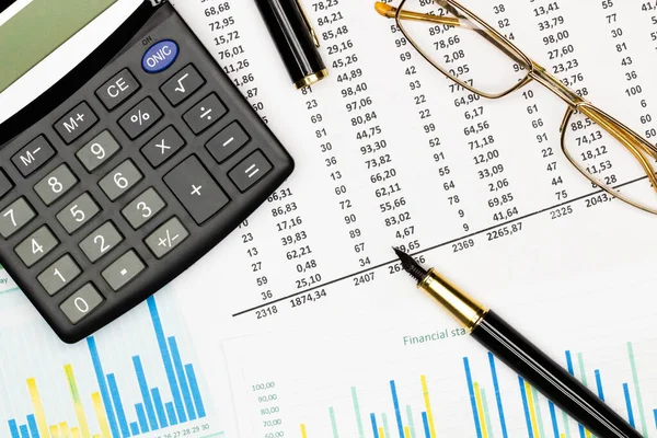 Top view office table desk. Financial report. Flat lay. Workspace with Business office supplies, Accounts number on the data paper, pen, glasses, calculator on the table. Top view. Close-up