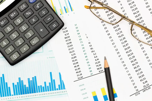 Top view office table desk. Financial report. Flat lay. Workspace with Business office supplies, Accounts number on the data paper, pencil, glasses, calculator on the table. Top view. Close-up