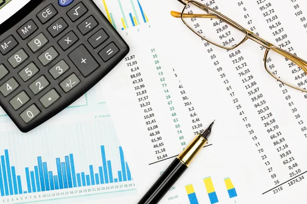 Top view office table desk. Financial report. Flat lay. Workspace with Business office supplies, Accounts number on the data paper, pen, glasses, calculator on the table. Top view. Close-up