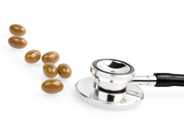 Medical pills near stethoscope — Stock Photo, Image