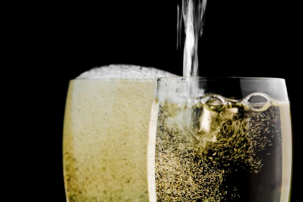 Full glasses of champagne and one being filled — Stock Photo, Image